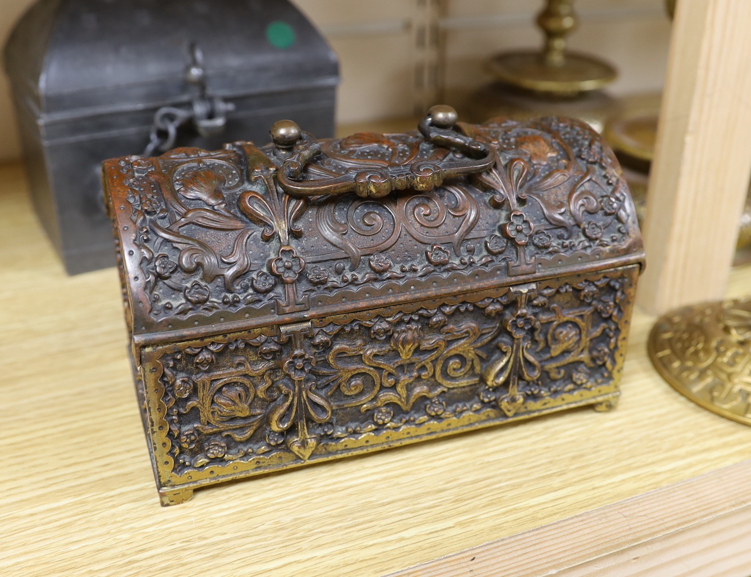 A Continental gilt brass casket, a pair of brass candlesticks, a pewter casket, another candlestick, a vase and a JVB hook (6)